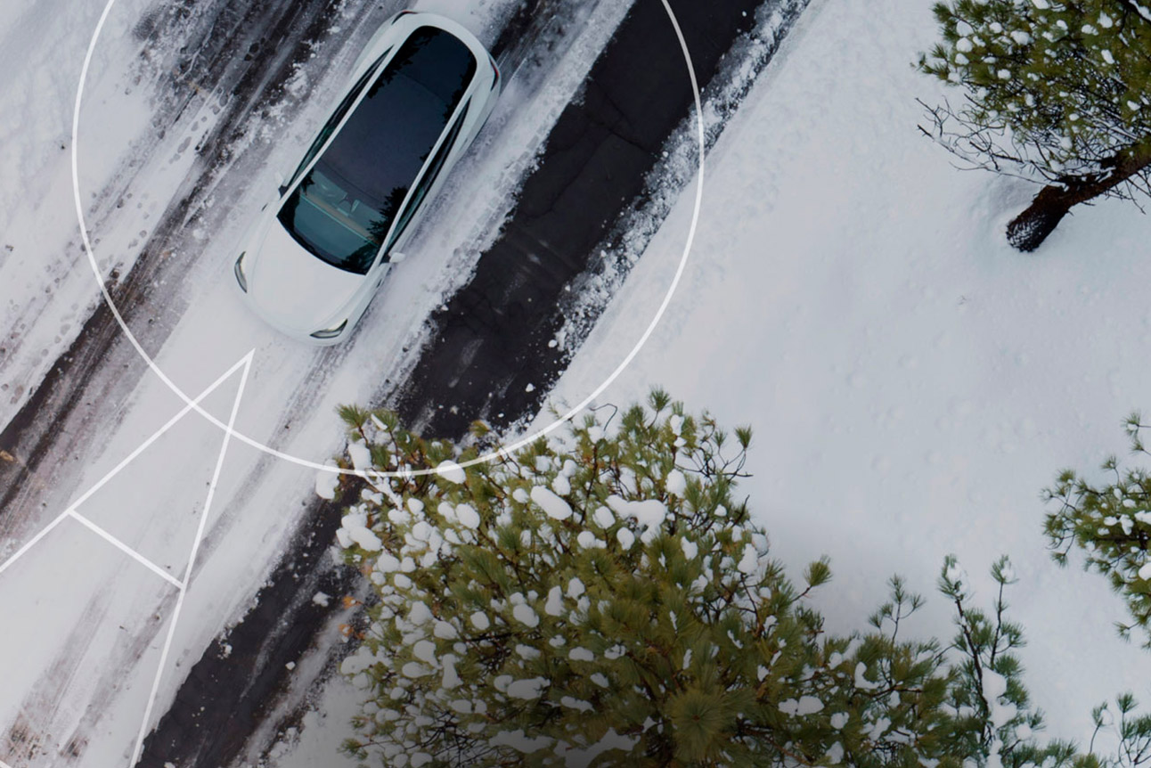 Car-shared Tesla through the Teneo app on a road in a snowy landscape
